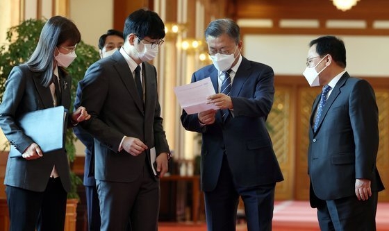 지난 5월 4일 문재인 당시 대통령이 청와대 본관에서 열린 백서 발간 기념 국정과제위원회 초청 오찬에 참석하며 탁현민 의전비서관에게 보고받고 있다. (사진=중앙일보)